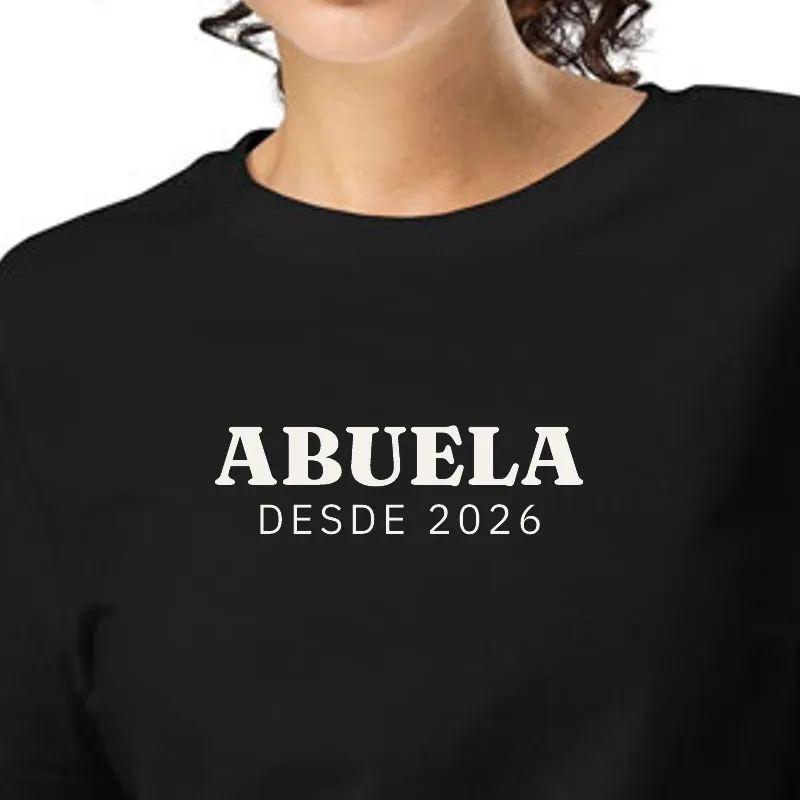 Dona amb samarreta negra, enquadrament al segell: ÀVIA · DES DEL 2026