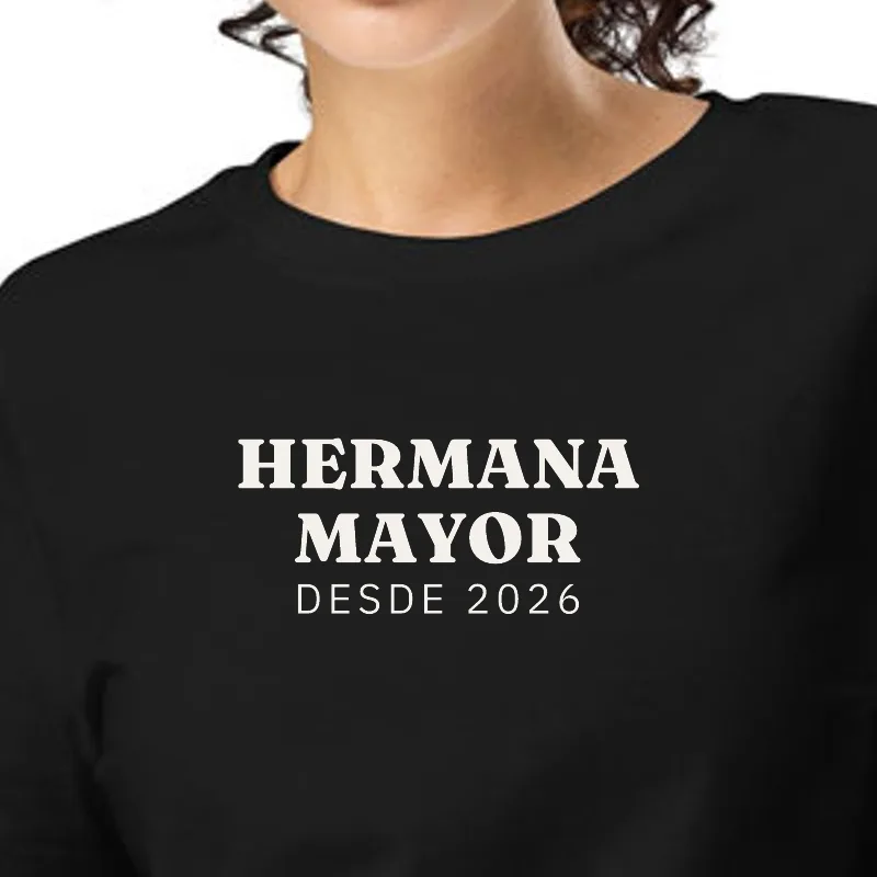 Dona amb samarreta negra, enquadrament al segell: GERMANA GRAN · DES DEL 2026